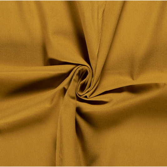 Close-up of mustard yellow needlecord fabric showing texture and details. Ideal for handmade vintage trousers.